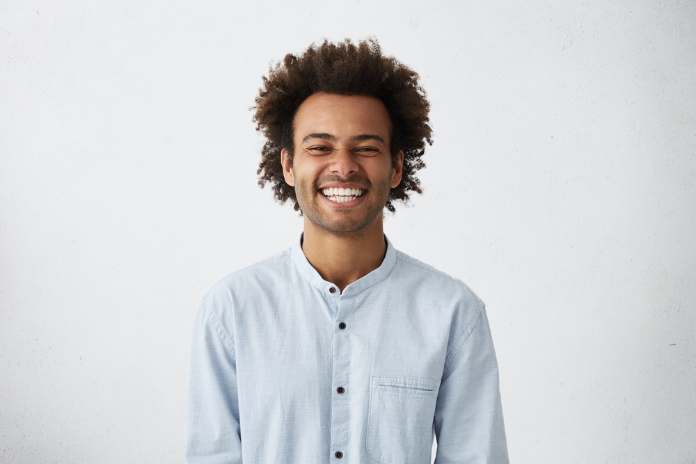 Smiling young man with curly hair